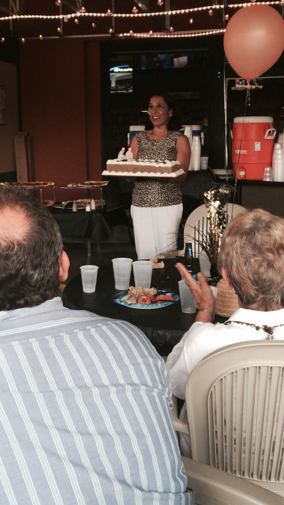 Trapper's Pizza Pub guest carries birthday cake out to the patio.