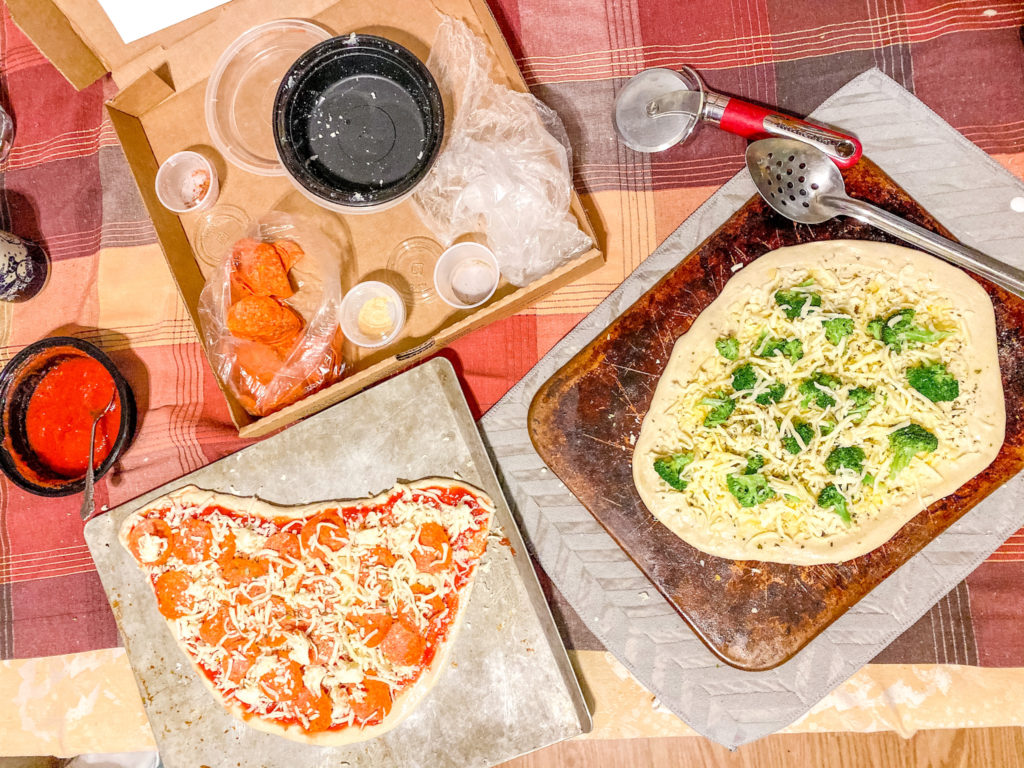 Two pizzas topped with Trapper's Pizza Pub's homemade sauce, mozzarella and toppings from our Make-Your-Own Pizza Kits.
